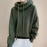 Olive green women's oversized hoodie featuring long sleeves and a cozy design, perfect for fall and winter fashion.