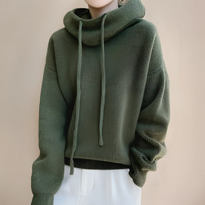 Olive green women's oversized hoodie featuring long sleeves and a cozy design, perfect for fall and winter fashion.
