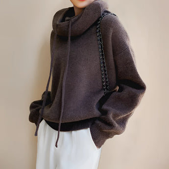 Olive green women's oversized hoodie featuring long sleeves and a cozy design, perfect for fall and winter fashion.