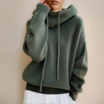 Olive green oversized hoodie for women, featuring a cozy design perfect for fall and winter fashion. The garment includes a spacious hood, long sleeves, and a relaxed fit, highlighting details like the shoulders and waist area.