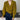 
A woman wearing an olive green V-neck wrap sweater paired with jeans, showcasing a casual yet chic autumn fashion look. The sweater features a draped neckline and long sleeves, emphasizing a relaxed and stylish fit.