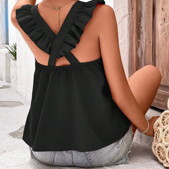 Orange sleeveless tank top with criss-cross back, worn by a woman, showcasing summer fashion style.