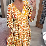 Orange and white geometric V-neck summer dress with a cinched waist, featuring short sleeves and designed as a day dress in size 5XL, shown in a yellow variant.