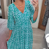 Orange white geometric V-neck summer dress with a cinched waist, showcasing blue and azure patterns, featuring short sleeves and a flowing one-piece garment design in size 5XL.