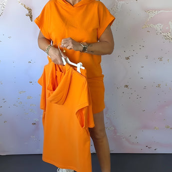 Orange women's casual shorts set featuring a drawstring, hooded top, perfect for summer wear. The set exudes a sense of fashion and comfort, with the vibrant orange color adding a cheerful and stylish touch.