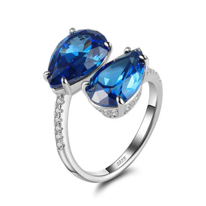Sterling silver double teardrop blue topaz ring with intricate design, featuring two teardrop-shaped blue topaz gemstones, set in a luxurious ORSA 925 band.