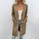 Oversized beige cable knit cardigan with a cozy texture, featuring an open front design and long sleeves.
