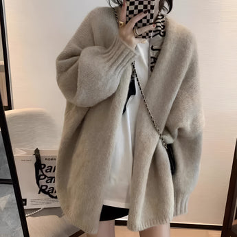 Oversized beige chunky knit women's cardigan featuring a cozy design, long sleeves, and a relaxed fit, perfect for winter fashion.