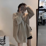 Oversized beige chunky knit women's cardigan with a cozy design, featuring long sleeves and a relaxed fit, suitable for winter fashion.