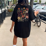Oversized beige t-shirt dress with floral embroidery, showcasing a comfortable fit with short sleeves and a relaxed silhouette, ideal for summer.