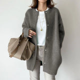 Cozy gray oversized wool cardigan for women, featuring long sleeves, a relaxed fit, and a warm collar, ideal for winter fashion.