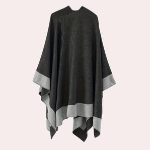 Oversized black designer poncho with an asymmetric design, featuring a stylish collar and long sleeves, perfect for winter.