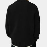 Men's oversized black ribbed knit sweater with a relaxed fit and crewneck design, featuring long sleeves.