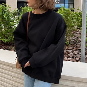 Oversized black sweatshirt for women, featuring a casual loose fit pullover design, shown in size 2XL with long sleeves and a round neckline.