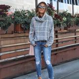 Oversized black and white checkered jacket in a trendy plus size design, featuring a tartan pattern and collared neckline. The model is wearing the jacket over a dress shirt and paired with jeans, standing confidently.