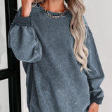 Oversized blue corduroy pullover women's long sleeve sweater worn by a smiling woman with long hair, showcasing the shoulder and arm details against a white background.