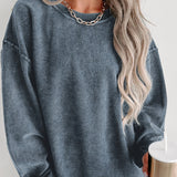 Oversized women's long sleeve pullover sweater in a blue corduroy fabric, featuring a relaxed fit with a drop shoulder design and ribbed cuffs.