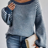 Oversized blue houndstooth chunky knit sweater for women, styled with jeans, highlighting the sweater's unique pattern and cozy texture, suitable for winter fashion.