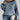 Oversized blue houndstooth chunky knit sweater for women, styled with jeans, highlighting the sweater's unique pattern and cozy texture, suitable for winter fashion.