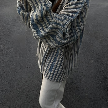 Oversized blue stripe knit sweater for women featuring long sleeves, shown on a model wearing sunglasses, highlighting autumn fashion style.