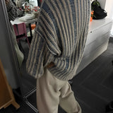 Oversized blue stripe knit sweater for women, featuring long sleeves and a comfortable fit ideal for autumn fashion.