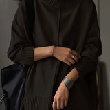 Oversized burnt orange women's crewneck sweater in chunky knitwear, showcasing long sleeves and a relaxed fit.