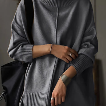 Oversized burnt orange women's crewneck sweater featuring a chunky knit design, displayed on a mannequin with emphasis on the shoulder and sleeve details.
