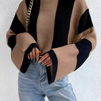 Oversized chunky knit sweater in black and tan stripes, featuring a relaxed fit with long sleeves and a round neckline, ideal for autumn fashion. The sweater is shown in a khaki color and size large, perfect for a cozy and stylish look.