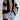 Oversized chunky black and tan striped knit sweater featuring long sleeves, perfect for autumn fashion. The sweater is modeled with jeans, showcasing a cozy and stylish look suitable for cooler weather.