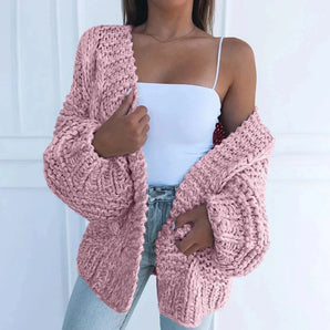 Oversized chunky blush pink cardigan in size 5XL, featuring long sleeves and a cozy fit for women's winter fashion, draped over a mannequin showcasing outerwear details like shoulder, arm, and waist.