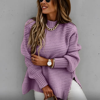 
A woman wearing an oversized chunky knit turtleneck sweater in a purple color, suitable for winter fashion. The sweater is in a 3XL size and features long sleeves. The woman is accessorizing with sunglasses.