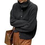 Oversized chunky knit women's brown wool turtleneck sweater with long sleeves and textured fabric.