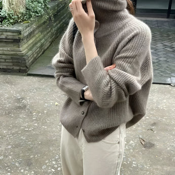 Oversized chunky knit women's brown wool turtleneck sweater featuring long sleeves and a cozy collar.