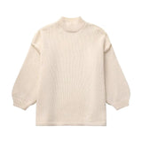 Oversized cream knit sweater in beige, featuring long sleeves and a cozy woolen texture, designed for elegant autumn fashion.