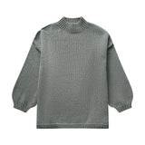 Oversized cream knit sweater with a green hue, featuring long sleeves and a textured woolen pattern, ideal for elegant autumn fashion.