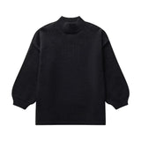 Oversized cream knit sweater featuring long sleeves and a subtle pattern, perfect for elegant autumn fashion.