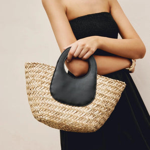 Oversized designer straw tote bag with black handle, featuring an eco-friendly design; suitable for fashion-forward individuals looking for a sustainable accessory.