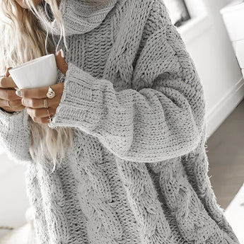 Woman wearing oversized gray chunky knit turtleneck sweater with cable pattern, 2XL size.