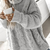 Women's oversized gray chunky knit turtleneck sweater with cable knit design, featuring long sleeves and a high collar.