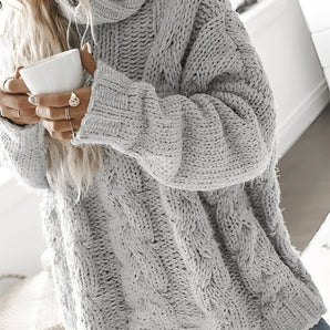 Women's oversized gray chunky knit turtleneck sweater with cable knit design, featuring long sleeves and a high collar.