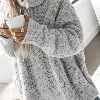 Women's oversized gray chunky knit turtleneck sweater with cable knit design, featuring long sleeves and a high collar.