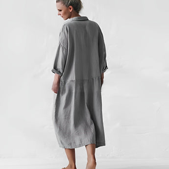 Oversized gray shirt dress with long sleeves and pockets, casual chic maxi style, size 2XL, modeled full-length showing legs and knees.