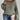 Oversized green striped knit sweater with a cozy boat neck pullover design, featuring long sleeves and a relaxed fit.