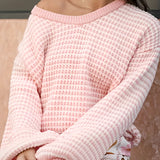 Oversized green and white striped knit sweater with a cozy boat neck design, shown on a model highlighting the loose fit and long sleeves.