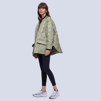 Oversized green women's quilted puffer jacket in Army Green, size L, lightweight and casual for autumn, featuring a stylish design with visible sleeves, waist, and thigh length, worn by a woman.
