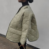 Oversized green women's quilted puffer jacket with collar and long sleeves, styled for a lightweight, casual autumn look.