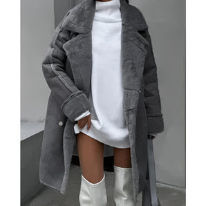 Oversized grey faux fur coat with long sleeves, showcasing cozy and chic winter fashion.