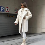 Oversized grey faux fur coat with a cozy chic winter design, featuring a broad collar and long sleeves, styled to provide warmth and a fashionable look.