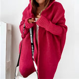 Oversized grey hoodie dress made of cozy knit fabric, featuring long sleeves, a relaxed fit, and large pockets. The dress is displayed in a red variant, size XL.