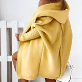 Oversized grey hoodie dress with a cozy knit texture, featuring long sleeves and convenient pockets.
